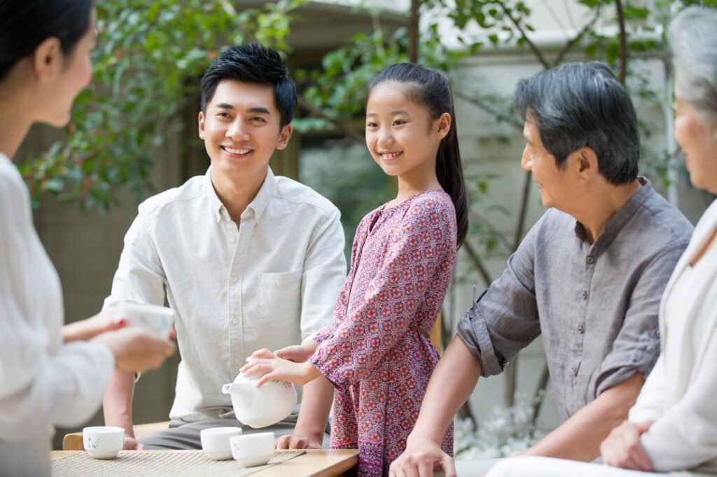 Happy family drinking tea together