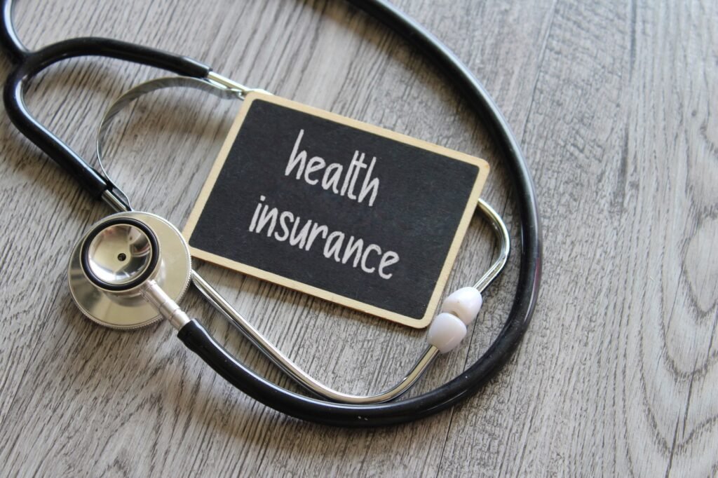 Insurance Accepted in Manvel, TX Stethoscope and chalkboard with text HEALTH INSURANCE on wooden table